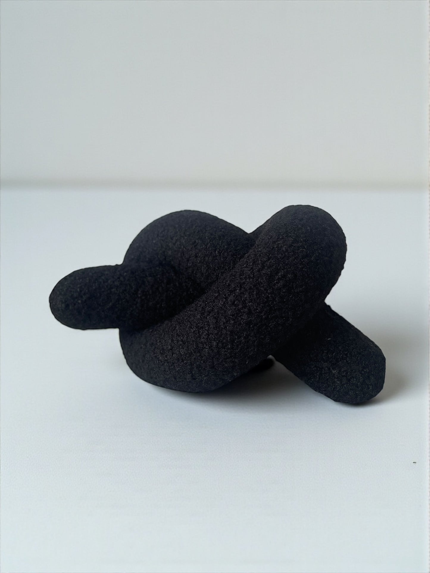 Black Boucle Knot Pillow: Modern Decorative Cushion
